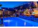 Backyard pool with water feature, hot tub, and outdoor kitchen with built in grill at 10038 W Redbird Rd, Peoria, AZ 85383