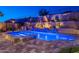Lush backyard with luxurious in-ground pool, outdoor kitchen, and desert landscaping on several tiers at 10038 W Redbird Rd, Peoria, AZ 85383