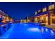 Spacious pool with spa, waterfall feature, covered patio, and manicured desert landscaping at 10038 W Redbird Rd, Peoria, AZ 85383