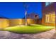 Backyard putting green with desert landscaping and ambient lighting at 10038 W Redbird Rd, Peoria, AZ 85383