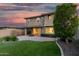 Well-maintained backyard with lush green grass, mature trees, covered patio, and seamless indoor-outdoor living at 11544 W Ashby Dr, Peoria, AZ 85383