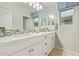 A bright bathroom with double sinks, quartz countertops and mosaic tiled backsplash at 11544 W Ashby Dr, Peoria, AZ 85383
