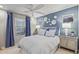 A blue themed bedroom with a queen sized bed, side tables, and lamps at 11544 W Ashby Dr, Peoria, AZ 85383