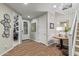 Bright entryway with wood floors and staircase to the second floor with a small office on the left at 11544 W Ashby Dr, Peoria, AZ 85383