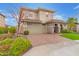 Attractive two-story home featuring a brick driveway, stone accents, and a well-manicured front yard at 11544 W Ashby Dr, Peoria, AZ 85383