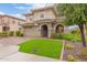 Charming two-story home with manicured lawn and archway leading to the front entrance at 11544 W Ashby Dr, Peoria, AZ 85383