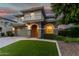 Beautiful two-story home with stone accents, an arched entry, and well-manicured landscaping at 11544 W Ashby Dr, Peoria, AZ 85383