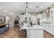Bright kitchen features a center island with chairs, wine rack and stainless appliances at 11544 W Ashby Dr, Peoria, AZ 85383