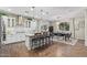 Bright, modern kitchen with stainless steel appliances, center island with chairs, and pendant lighting at 11544 W Ashby Dr, Peoria, AZ 85383