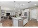 Open concept kitchen with large island, stainless steel appliances and a view into the living area at 11544 W Ashby Dr, Peoria, AZ 85383