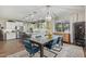 Dining area with modern chandelier leading into an open kitchen with stainless steel appliances at 11544 W Ashby Dr, Peoria, AZ 85383