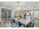 Bright, open space featuring a dining table that flows into an open concept kitchen and living space at 11544 W Ashby Dr, Peoria, AZ 85383