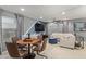 Inviting living area with a round table, comfortable seating, and a large screen TV at 11544 W Ashby Dr, Peoria, AZ 85383