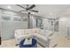 Cozy living room with a sectional sofa, modern ceiling fan, and stylish decor at 11544 W Ashby Dr, Peoria, AZ 85383