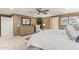 This is a neutral main bedroom with a dresser, large mirror, and white bedding at 11544 W Ashby Dr, Peoria, AZ 85383