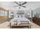 Bright main bedroom featuring a large bed, neutral tones, ceiling fan, and stylish decor at 11544 W Ashby Dr, Peoria, AZ 85383