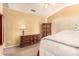 Well-lit bedroom showcasing a ceiling fan, plush carpet, and dark wood furniture at 13001 W Bloomfield Rd, El Mirage, AZ 85335