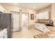Bright kitchen with stainless appliances, white cabinets, and tile flooring at 13001 W Bloomfield Rd, El Mirage, AZ 85335