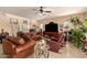 Spacious living room with leather furniture, tile floors, and a staircase at 13001 W Bloomfield Rd, El Mirage, AZ 85335