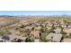 Aerial view of a desert community showcasing lush landscaping, tile roofs, and mountain views in the distance at 13064 W Big Oak St, Peoria, AZ 85383