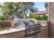 Built-in stainless steel gas grill with side burner on a stucco counter, perfect for outdoor cooking at 13064 W Big Oak St, Peoria, AZ 85383