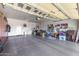 Spacious garage with ample storage, epoxy floor, and pegboard wall, providing practical organization solutions at 13064 W Big Oak St, Peoria, AZ 85383