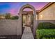 A beautiful wrought iron gate provides access to a private courtyard with lush desert landscaping at 13064 W Big Oak St, Peoria, AZ 85383
