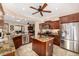 A gourmet kitchen features custom cabinetry, granite countertops, stainless steel appliances, and a center island at 13064 W Big Oak St, Peoria, AZ 85383