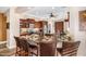 Eat-in kitchen featuring a large island with a sink, counter seating, and stainless steel appliances at 13064 W Big Oak St, Peoria, AZ 85383