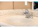 Bathroom sink featuring a chrome faucet and decorative mosaic backsplash at 13064 W Big Oak St, Peoria, AZ 85383
