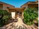 Inviting front porch featuring a cozy seating area, lush greenery, and a well-maintained walkway leading to the entrance at 13275 W Bolero Dr, Sun City West, AZ 85375