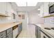 Open-concept kitchen with white and gray cabinetry and open access to the living area at 13275 W Bolero Dr, Sun City West, AZ 85375