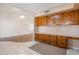 Spacious office with wood cabinets and desk space adjacent to the living area at 13275 W Bolero Dr, Sun City West, AZ 85375