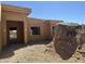 Side view of the home during the construction phase with exposed plywood and rock feature at 13515 N Granite Way, Fountain Hills, AZ 85268