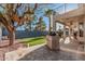 Backyard with built-in grill, mature trees and patio providing ample outdoor living space at 1449 W Commerce Ave, Gilbert, AZ 85233