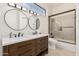 Bright bathroom showcasing double sinks, modern fixtures, and a tiled walk-in shower at 1449 W Commerce Ave, Gilbert, AZ 85233