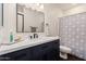 Bathroom featuring an elegant vanity with a large mirror and modern fixtures at 1449 W Commerce Ave, Gilbert, AZ 85233