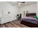 Comfortable bedroom with laminate floors, bright decor, and a dedicated workspace at 1449 W Commerce Ave, Gilbert, AZ 85233