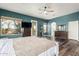 Large primary bedroom with private balcony access, laminate floors, and en suite bathroom at 1449 W Commerce Ave, Gilbert, AZ 85233