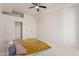 A simple bedroom featuring a ceiling fan and natural lighting at 1449 W Commerce Ave, Gilbert, AZ 85233