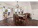 Bright dining room features a rustic wood table, chandelier, and view of outdoor patio at 1449 W Commerce Ave, Gilbert, AZ 85233