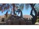 Unique dragon statue feature in the yard, set amongst decorative rock and desert landscaping at 1449 W Commerce Ave, Gilbert, AZ 85233