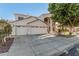 Elegant stucco home featuring a three-car garage and a beautiful arched entryway with a balcony at 1449 W Commerce Ave, Gilbert, AZ 85233