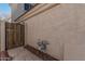 A utility access point is next to a private wooden entry gate outside this property at 1449 W Commerce Ave, Gilbert, AZ 85233