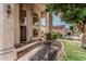 Grand home entrance with tall windows, decorative pillars, and a cozy outdoor seating area at 1449 W Commerce Ave, Gilbert, AZ 85233