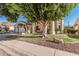 Charming home with mature shade tree, lush green lawn, and meticulous rock landscaping at 1449 W Commerce Ave, Gilbert, AZ 85233