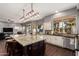 Bright kitchen with granite countertops, stainless appliances, large center island, and hardwood floors at 1449 W Commerce Ave, Gilbert, AZ 85233