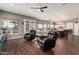 Comfortable living room with hardwood floors, ceiling fan, and view into the kitchen at 1449 W Commerce Ave, Gilbert, AZ 85233