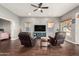Bright living room features hardwood floors, ceiling fan, and comfortable reclining chairs at 1449 W Commerce Ave, Gilbert, AZ 85233