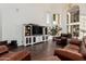 Comfortable living room featuring hardwood floors, large windows, and stylish entertainment center at 1449 W Commerce Ave, Gilbert, AZ 85233